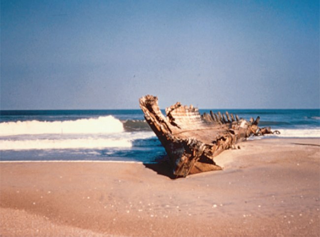 CAHA sediment beach with remnants of a ship