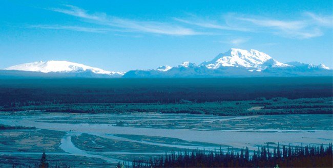 WRST wrangell and drum@10x wide river with snow covered mountains in the distance