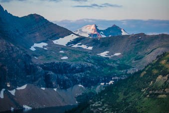 A mountainous landscape with a glacier beyond a ridge.