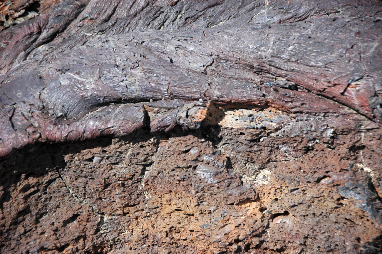 49415411828_ba012bd588_o Photo of a contact between ropy and blocky lava rocks.